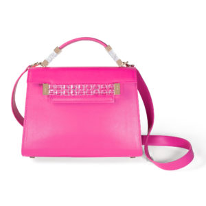 Front view of fuchsia pink Jewel Satchel with a tapered trapezoidal shape, matching pink top handle, clear Swarovski crystal and yellow gold top handle and front strap, and fuchsia pink detachable shoulder strap.