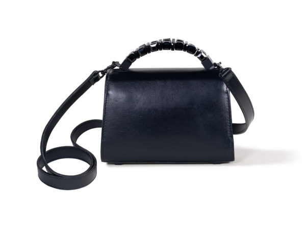 Back view of Mini Jewel Top Handle handbag in smooth black Italian leather. The shoulder strap has a tonal black clasp that attaches to a black ring fixed to the base of the top handle hardware.