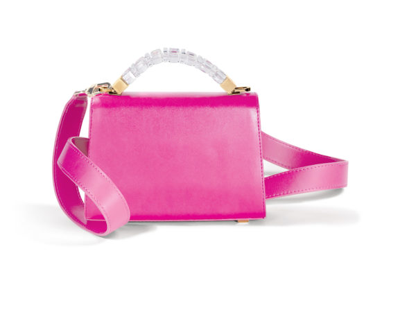 Back view of Mini Jewel Top Handle handbag in smooth fuchsia pink Italian leather. The shoulder strap has a yellow gold clasp that attaches to a yellow gold ring fixed to the base of the top handle hardware.
