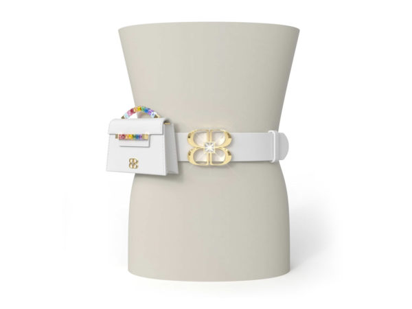 White Italian leather belt attached to form waist with large yellow gold and clear crystal BB logo stretching just above and below the belt. To the side of the BB logo, the white Rainbow Baby Jewel Crossbody bag is attached to the belt.