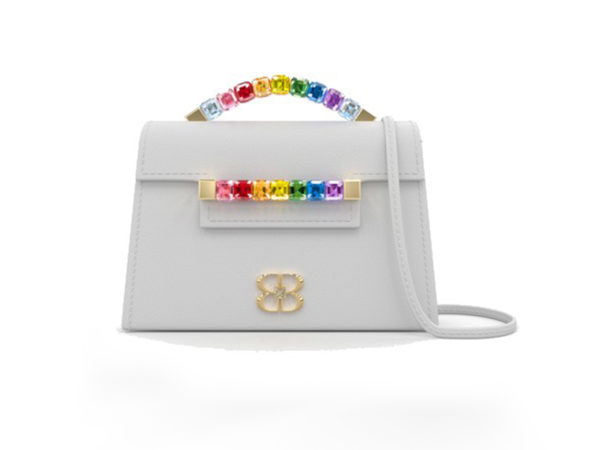 Front view of white Rainbow Baby Jewel Crossbody bag with a tapered trapezoidal shape, multi-colored Swarovski crystal top handle and front strap, yellow gold hardware, yellow gold and crystal BB plaque, and white detachable shoulder strap.