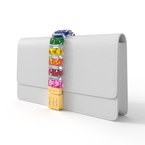 Side angle view of Over The Rainbow Clutch highlighting the rainbow-gradient of Swarovski crystals with alternating clear crystal dividers. The handbag has a slender, collapsible side profile.