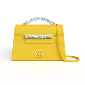 Front view of lemon yellow Baby Jewel Crossbody bag with a tapered trapezoidal shape, clear Swarovski crystal top handle and front strap, yellow gold hardware, yellow gold and crystal BB plaque, and matching yellow detachable shoulder strap.