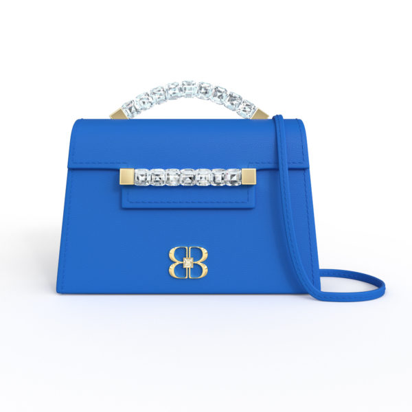 Front view of bright blue Baby Jewel Crossbody bag with a tapered trapezoidal shape, clear Swarovski crystal top handle and front strap, yellow gold hardware, yellow gold and crystal BB plaque, and matching blue detachable shoulder strap.